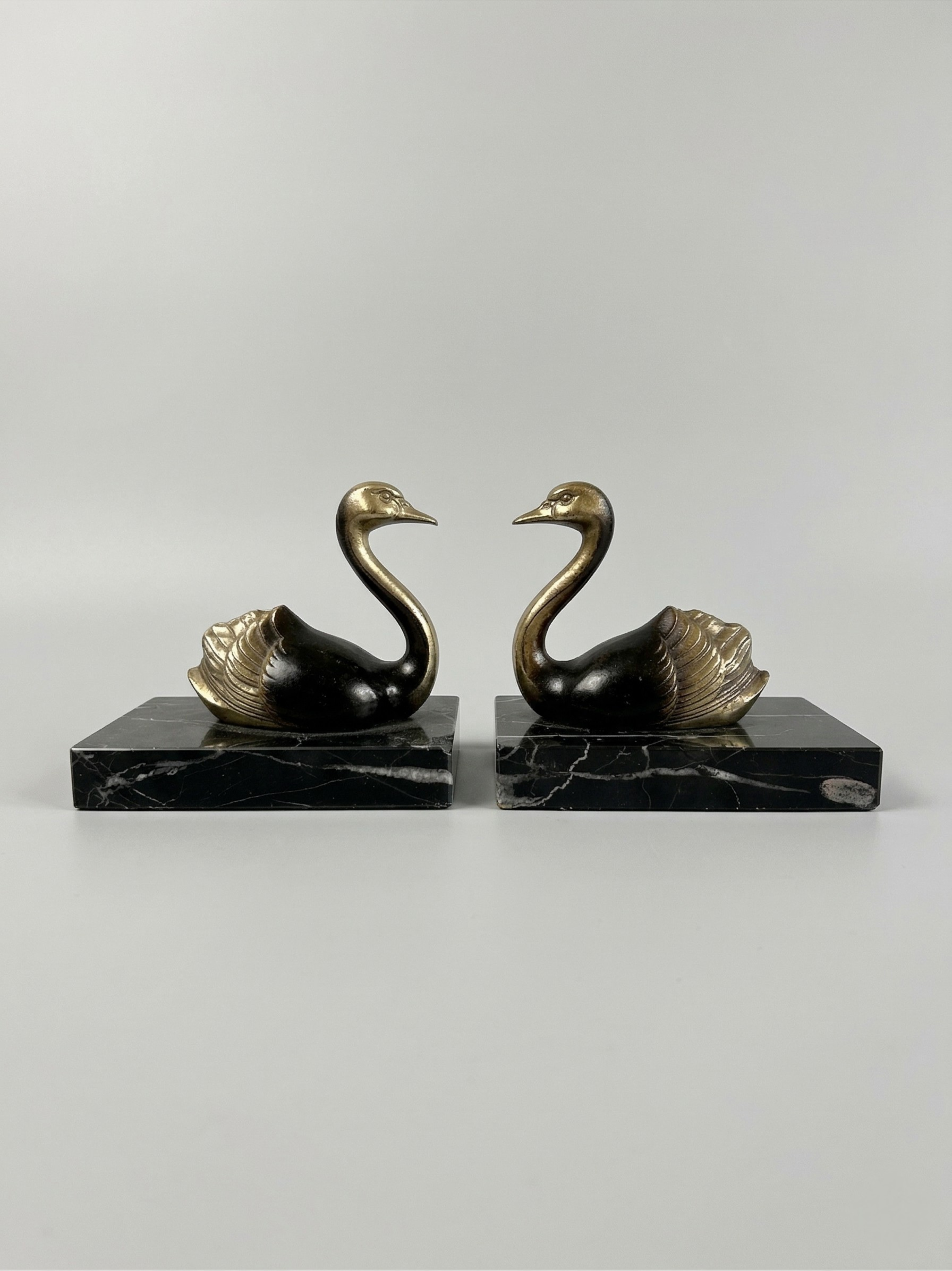 Pair of Art Deco bookends with swans in spelter and black marble – France, 1930s
