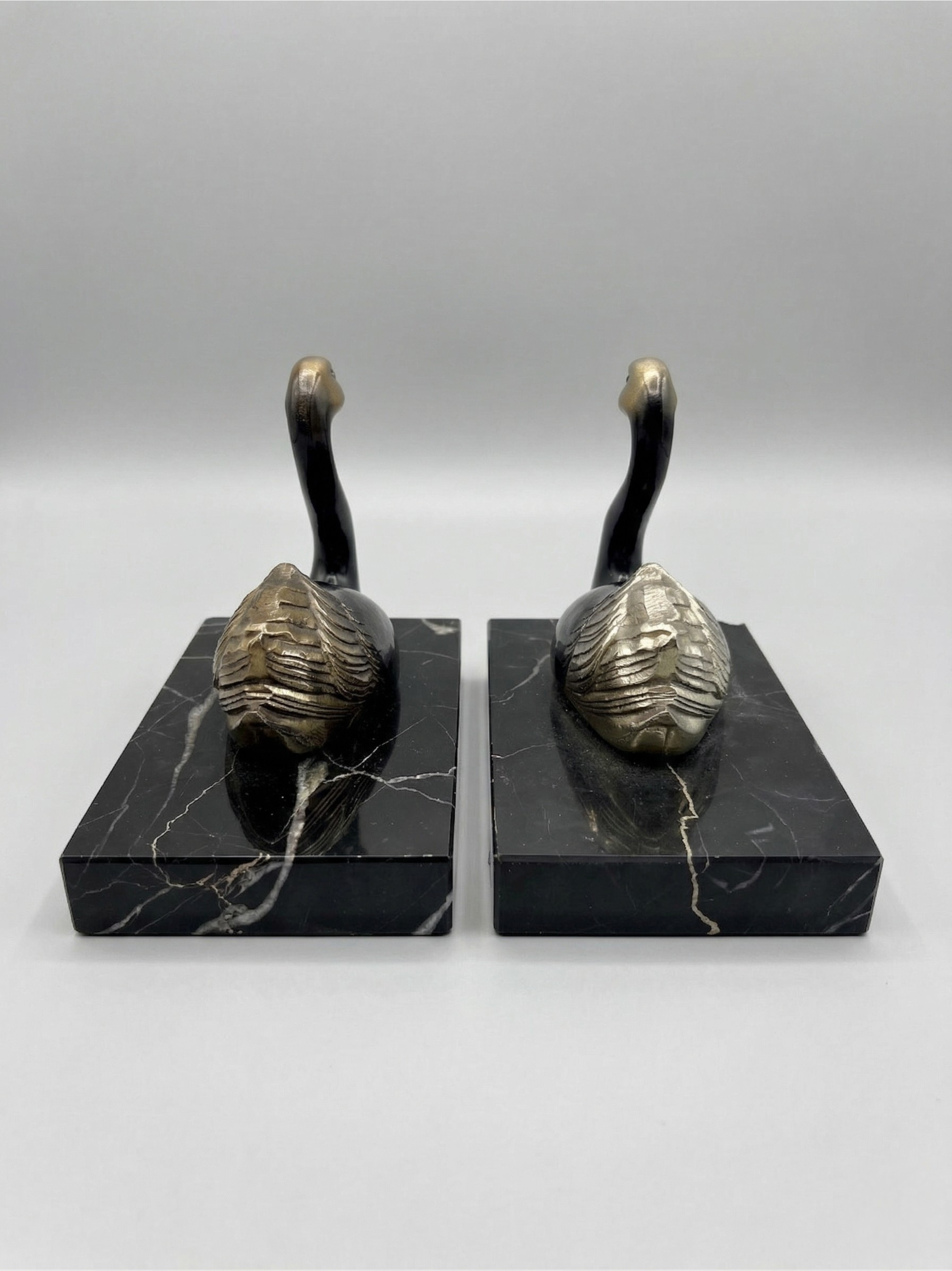 Pair of Art Deco bookends with swans in spelter and black marble – France, 1930s