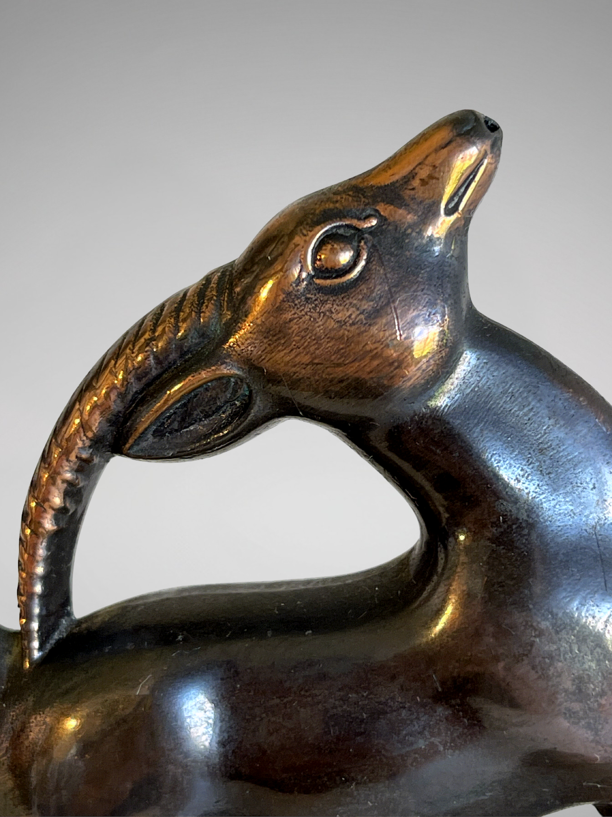 Art Deco bookends in patinated spelter – stylized animal pair – taupe marble bases – 1930s